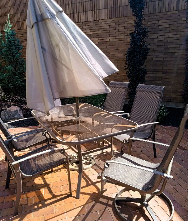 Umbrella-covered tables at Ella's Garden, Barrhead Healthcare Center