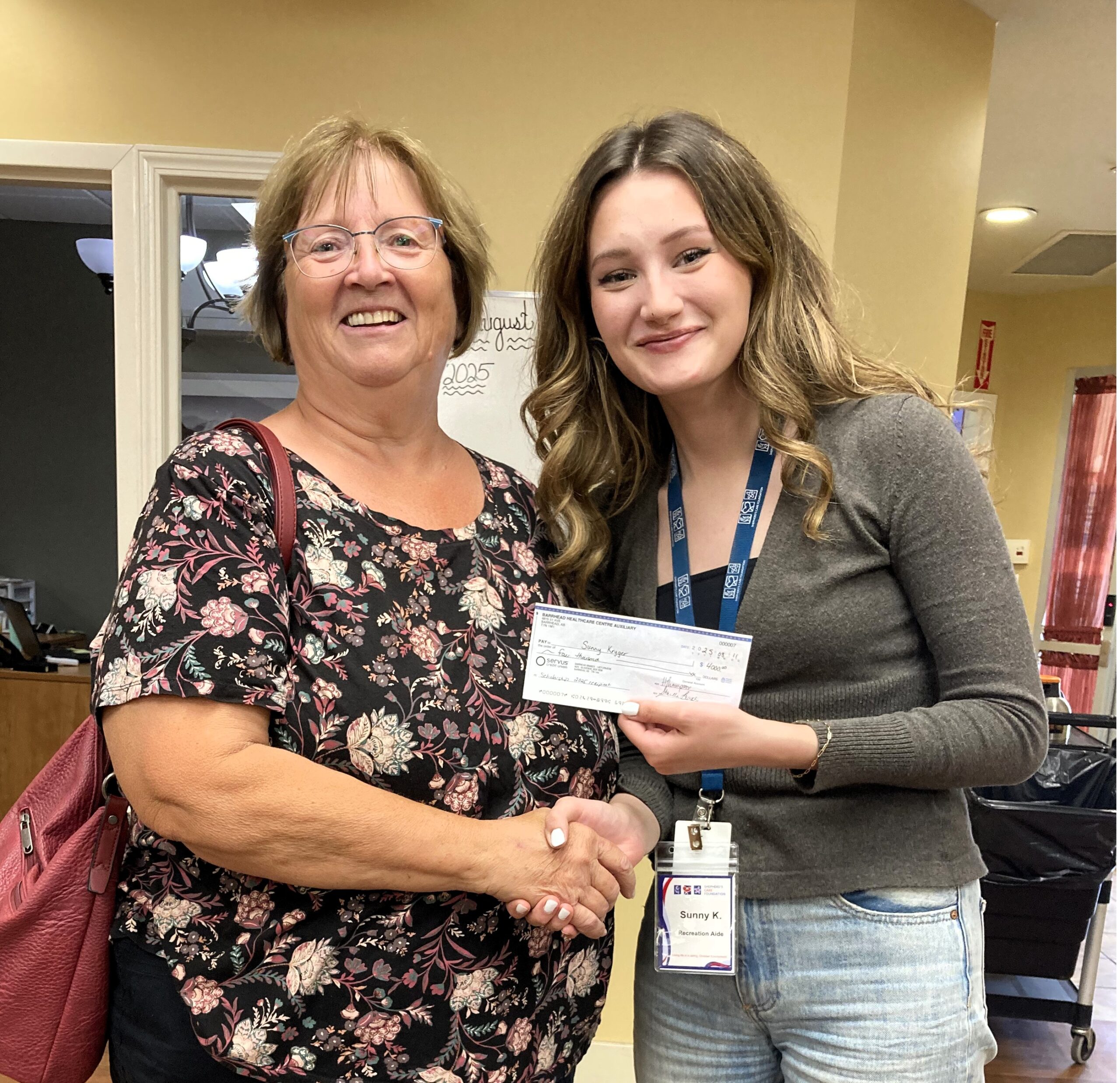 BHCA president presenting Sunny Kryger with her Dr. Bose Scholarship Cheque